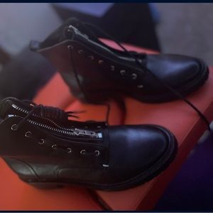 A sleek zipper crowns the front of this sleek leather boot